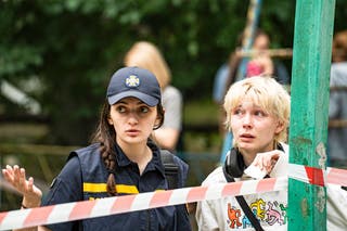 A Ukrainian woman speaks with a first respondent because it is waiting for news that her loved ones probably was buried under the rubble of a destroyed building in the bag, where a complete building crashed as a result of a direct missile